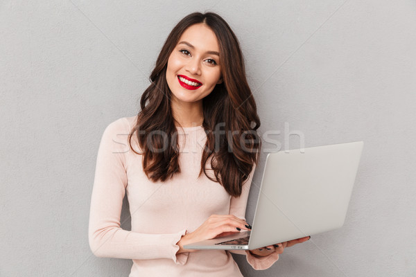 Stock photo: Portrait of smart female 30s with beautiful smile holding silver