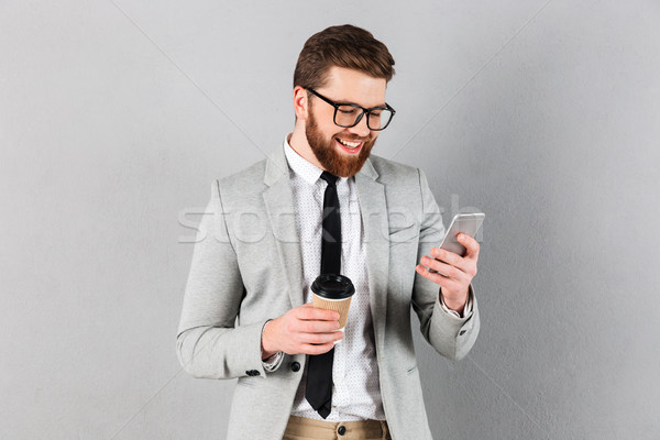 ストックフォト: 肖像 · 笑みを浮かべて · ビジネスマン · スーツ · 眼鏡 · 携帯電話