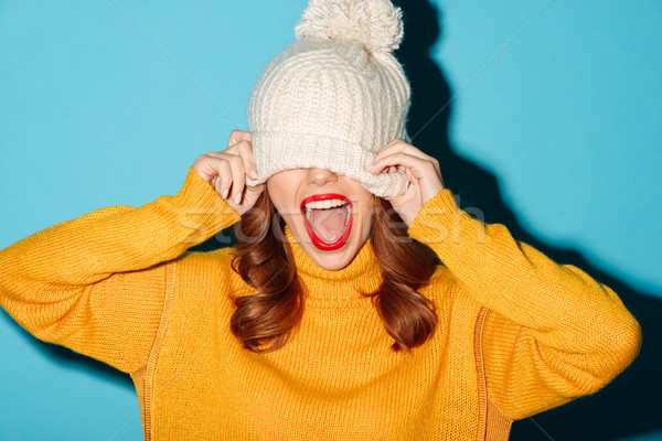 Portrait of a cheery young girl dressed in winter hat Stock photo © deandrobot
