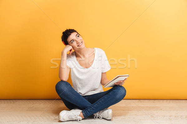 Portré álomszerű fiatal nő tart notebook ül Stock fotó © deandrobot