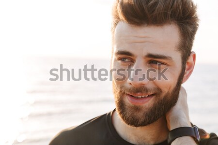 Close up of handsome young sport man looking away Stock photo © deandrobot