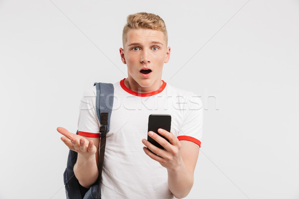Image of surprised male student having clean healthy skin wearin Stock photo © deandrobot