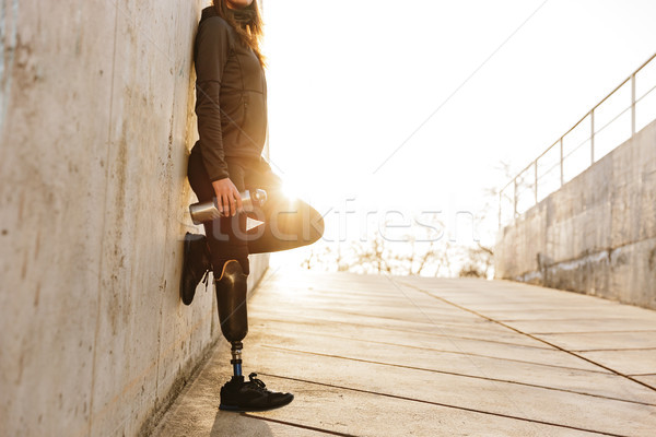 Cropped photo of handicapped woman with prosthesis leg in sports Stock photo © deandrobot
