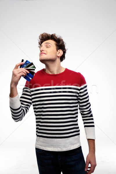 Stockfoto: Gelukkig · jonge · man · creditcards · grijs · glimlach