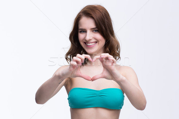Mutlu gülümseyen kadın el ele tutuşarak kalp şekli el gülümseme Stok fotoğraf © deandrobot