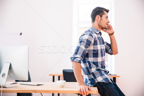 Handsome businessman talking on the phone Stock photo © deandrobot