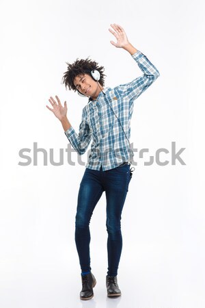 Afro american man listening  music in headphones and dancing Stock photo © deandrobot