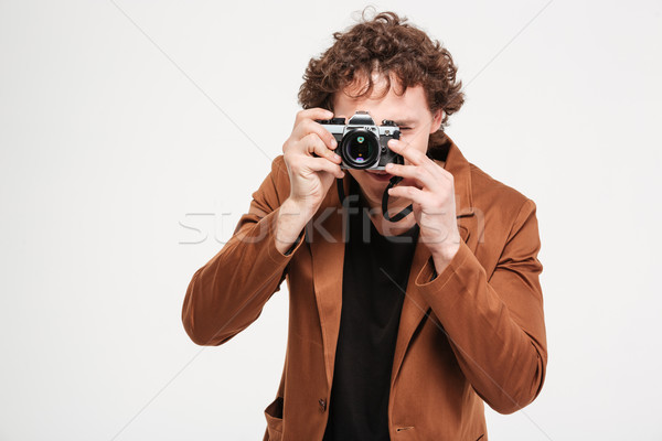 Man photographing on retro camera  Stock photo © deandrobot