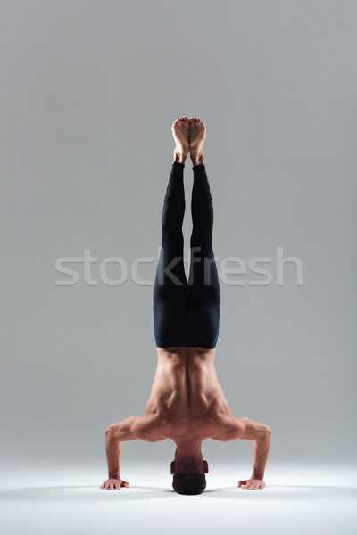 Man doing headstand Stock photo © deandrobot