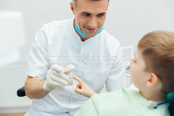 Sonriendo hombre dentista dentales mandíbula Foto stock © deandrobot