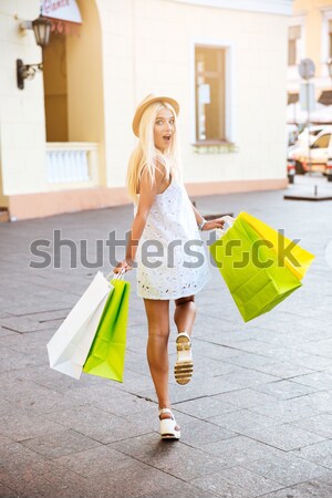 Belo jovem mulher loira caminhada rua vestido branco Foto stock © deandrobot