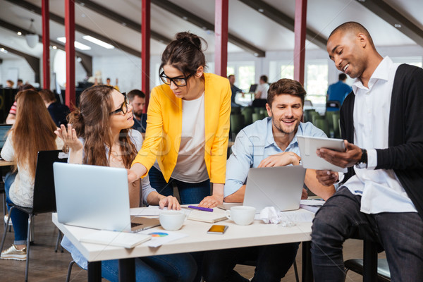 Group of smiling business people working together in office Stock photo © deandrobot