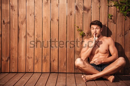 Jeunes élégant souriant homme séance [[stock_photo]] © deandrobot