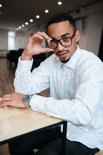 Serious african businessman coworking. Stock photo © deandrobot