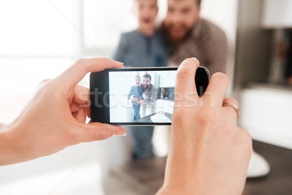 Father in the kitchen with his birthday son making selfie Stock photo © deandrobot