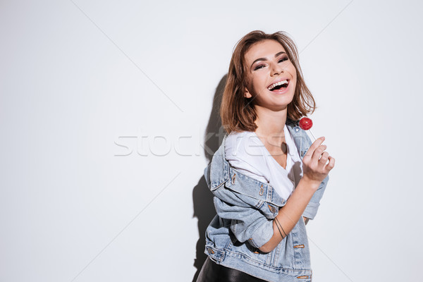 Attractive lady holding candy. Stock photo © deandrobot