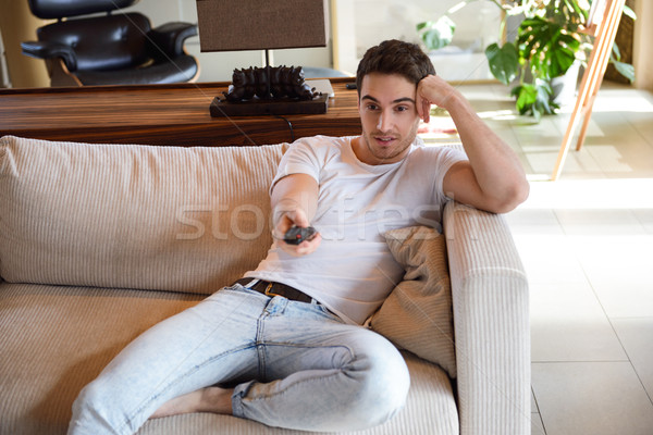 Man using remote controller Stock photo © deandrobot