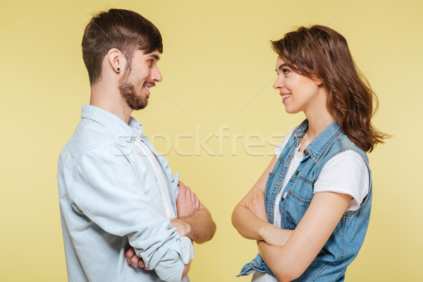 Happy brother and sister over yellow background Stock photo © deandrobot