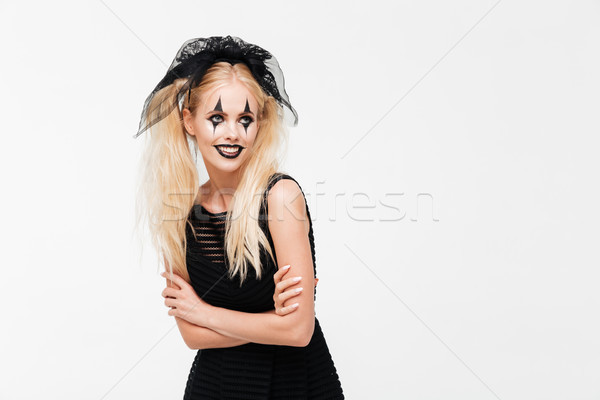 Glimlachend blonde vrouw zwarte weduwe kostuum poseren Stockfoto © deandrobot