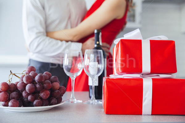 Close up shot of gift boxes, bottle of wine and grape on table Stock photo © deandrobot
