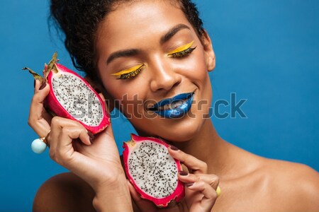 Horizontal photo of stylish mulatto woman with colorful makeup a Stock photo © deandrobot