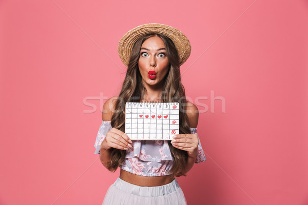 Portrait of astonished european woman 20s wearing straw hat hold Stock photo © deandrobot