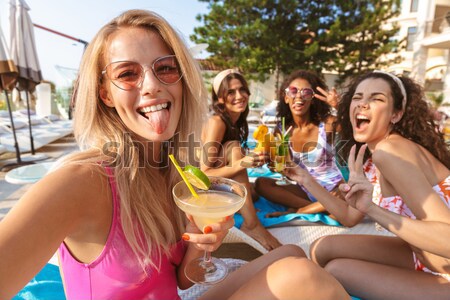 Back view image of four attractive young women Stock photo © deandrobot