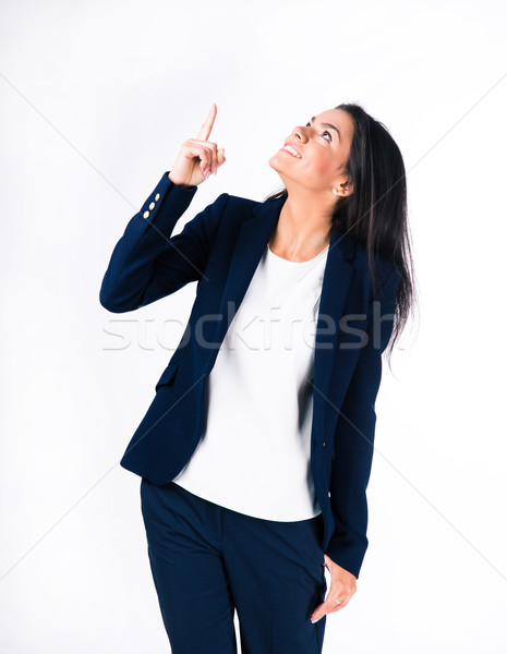 Smiling businesswoman pointing finger up Stock photo © deandrobot