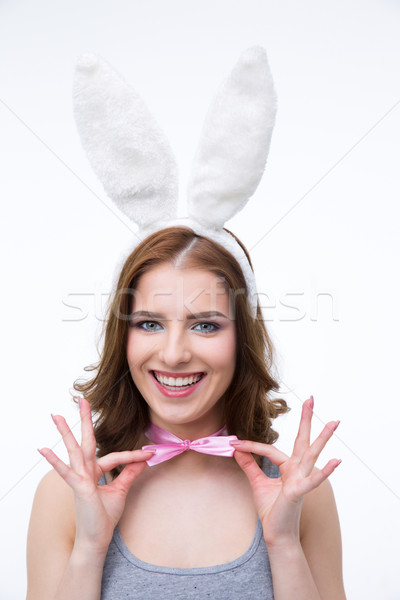 Happy woman in rabbit ears holding her butterfly over gray background Stock photo © deandrobot