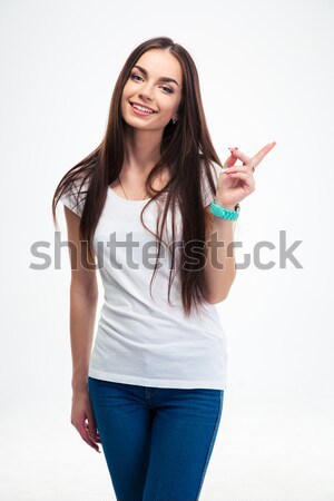 Smiling woman pointing finger away Stock photo © deandrobot