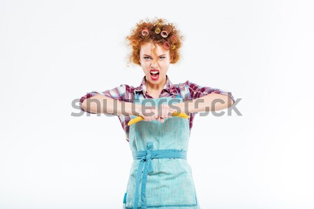 Wondered housewife holding yellow gloves in both hands  Stock photo © deandrobot