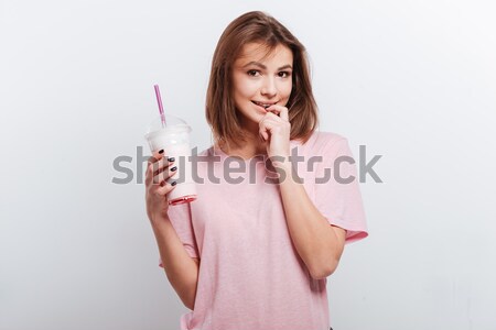 Lovely charming young woman in pink sweatshirt sending a kiss  Stock photo © deandrobot