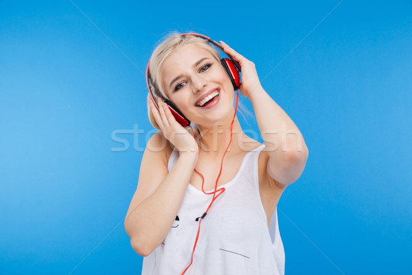 Female teenager listening music in headset Stock photo © deandrobot