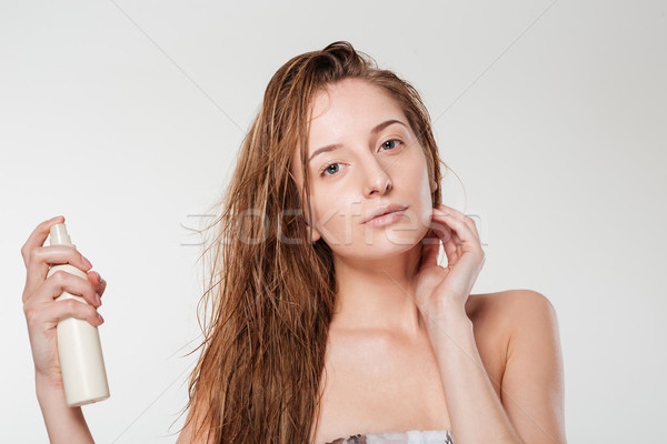 Young woman spraying hairspray Stock photo © deandrobot