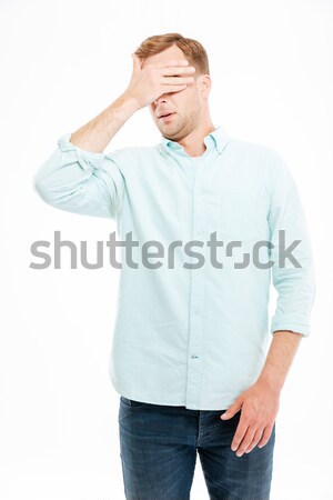Handsome young businessman covered his eyes by hand Stock photo © deandrobot