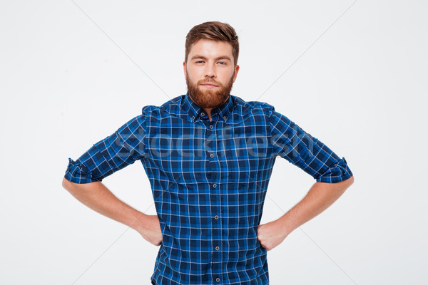 Young handsome man gazing camera isolated Stock photo © deandrobot