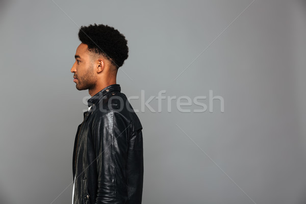 Side view photo of handsome serious african boy with stylish hai Stock photo © deandrobot