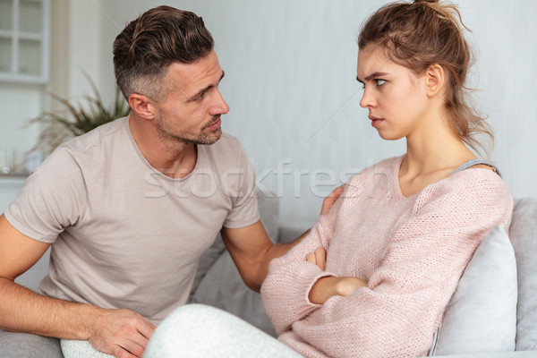 Side view of attentive man sitting on couch Stock photo © deandrobot