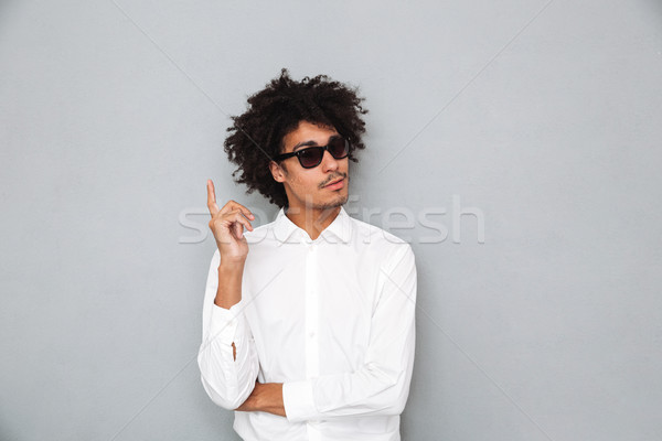 Portrait of a successful young african man in white shirt Stock photo © deandrobot