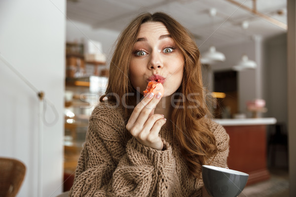 Portrait closeup of satisfied european woman sitting at table, a Stock photo © deandrobot