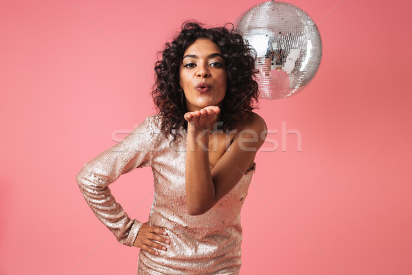 Portrait of a happy african woman in shiny dress Stock photo © deandrobot