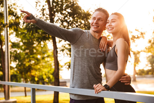 Image of beautiful caucasian sporty man and woman 20s in tracksu Stock photo © deandrobot