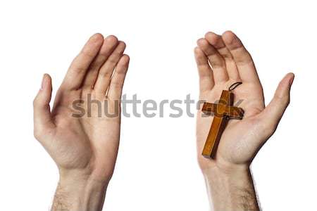 Male hand holding wooden cross on white background Stock photo © deandrobot