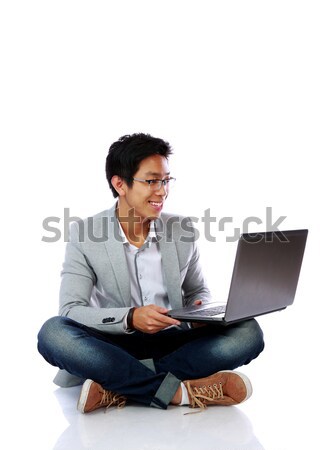 улыбаясь азиатских человека сидят полу используя ноутбук Сток-фото © deandrobot