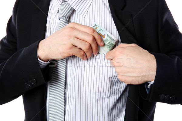 Businessman putting money in pocket isolated on white background Stock photo © deandrobot