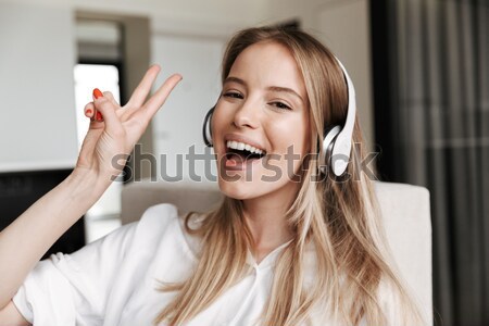 Young cute smiling girl showing OK sign Stock photo © deandrobot