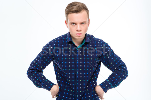 Mad angry handsome young male with hands on waist Stock photo © deandrobot
