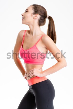 Profile of pretty positive young sportswoman in sports clothes  Stock photo © deandrobot