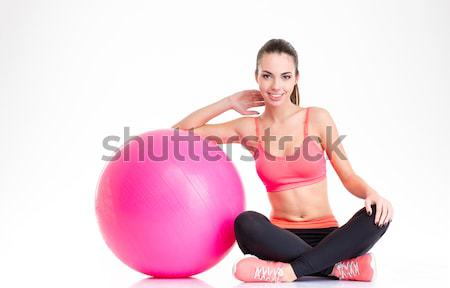Gyönyörű boldog fitnessz lány ül pózol Stock fotó © deandrobot