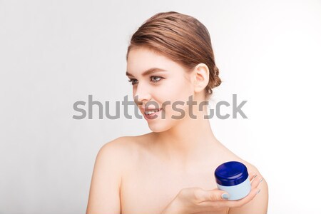 Woman holding moisturizing facial cream Stock photo © deandrobot